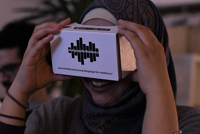 Taking a virtual tour of the Language for Resilience exhibition using Google Cardboards. © British Council